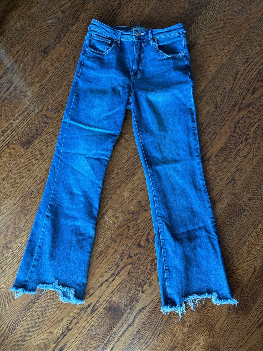 Risen High-Rise Flare Jeans in Blue with Raw Hem